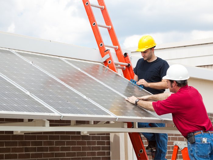 Solar electricians installing solar panels